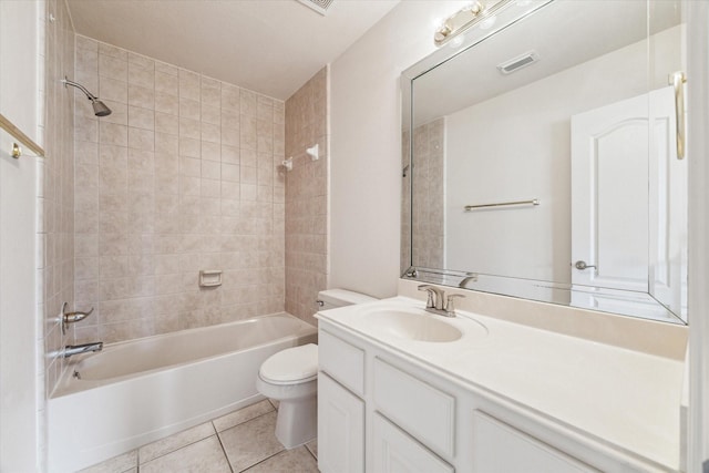 full bathroom featuring tiled shower / bath, tile patterned floors, toilet, and vanity