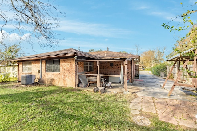 back of property featuring a lawn, central AC, and a patio