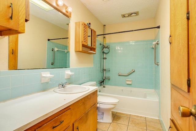 full bathroom featuring a textured ceiling, tiled shower / bath combo, tile patterned floors, tile walls, and toilet