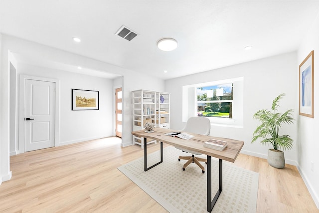 office featuring recessed lighting, light wood-type flooring, visible vents, and baseboards