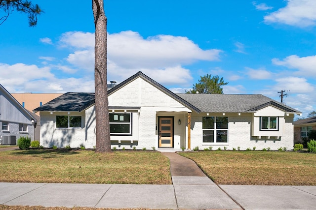 view of front facade with central AC and a front lawn