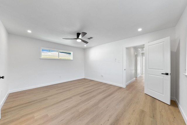 unfurnished room with ceiling fan and light wood-type flooring