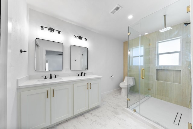 bathroom with vanity, toilet, and a shower with door