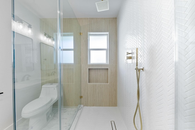 bathroom featuring a shower and toilet