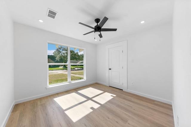 spare room featuring ceiling fan and light wood-type flooring