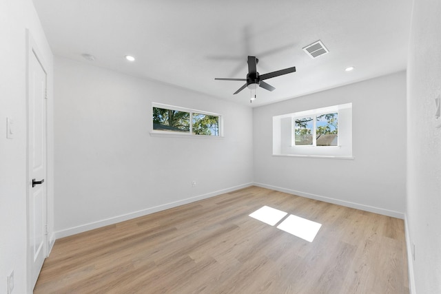 unfurnished room with light hardwood / wood-style flooring, plenty of natural light, and ceiling fan