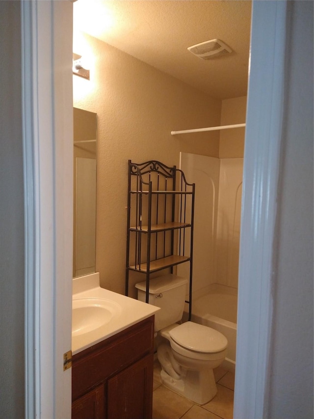 full bathroom featuring vanity, bathing tub / shower combination, tile patterned flooring, toilet, and a textured ceiling