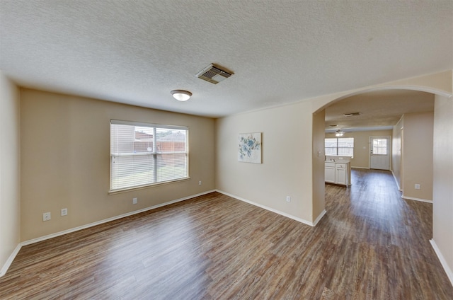 unfurnished room with ceiling fan, hardwood / wood-style floors, and plenty of natural light