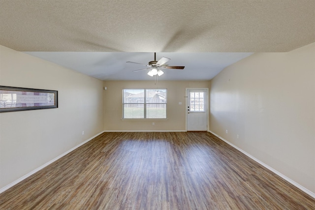 unfurnished room with hardwood / wood-style flooring, ceiling fan, lofted ceiling, and a textured ceiling