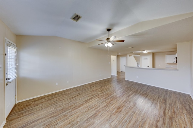 unfurnished living room with light hardwood / wood-style floors, vaulted ceiling, and ceiling fan