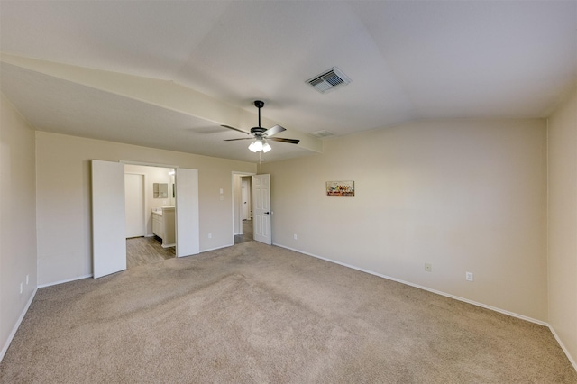 unfurnished bedroom with light carpet, ensuite bathroom, ceiling fan, and lofted ceiling