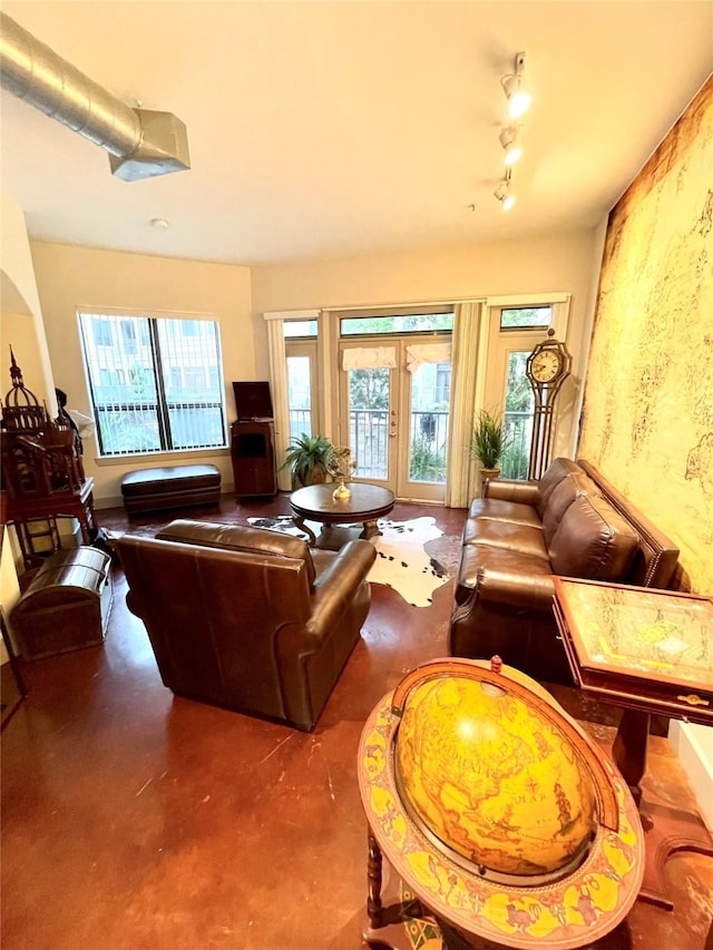 living room featuring french doors and concrete floors