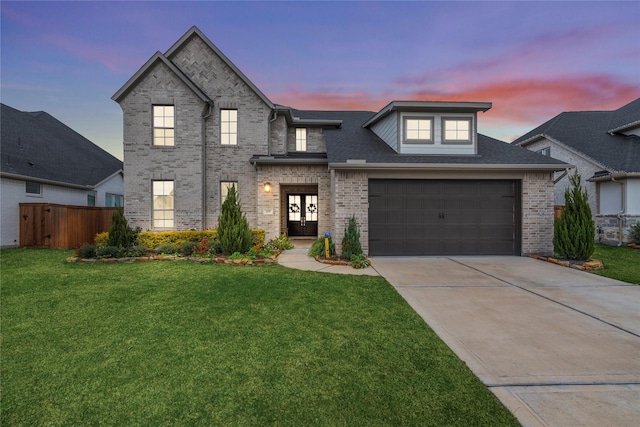 view of front of property with a lawn, a garage, and french doors