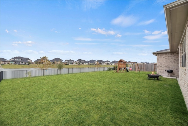 view of yard featuring a playground and a water view