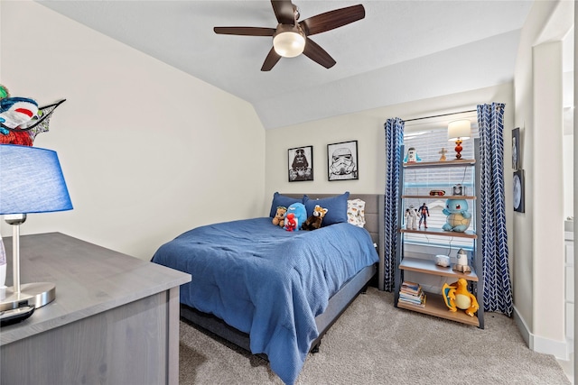 bedroom with ceiling fan, light colored carpet, and vaulted ceiling