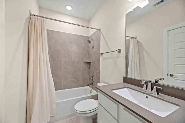 full bathroom featuring vanity, shower / bath combo, and toilet