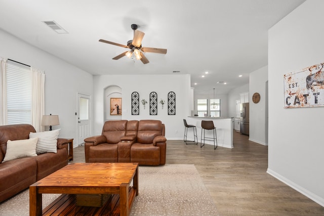 living room featuring hardwood / wood-style flooring and ceiling fan