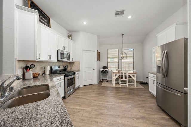 kitchen with white cabinets, appliances with stainless steel finishes, and sink