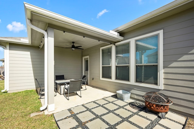 view of patio featuring ceiling fan and a fire pit