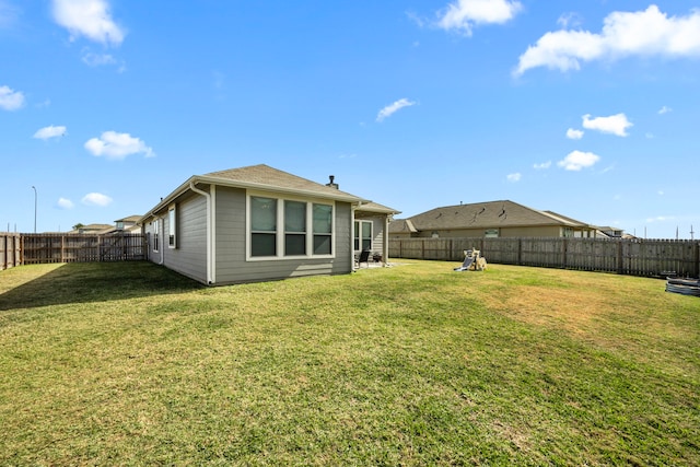 back of property with a lawn