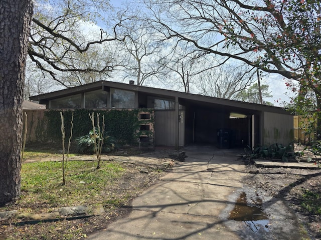 view of front of house featuring an attached carport and concrete driveway