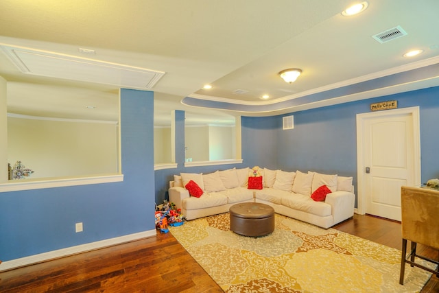 living room featuring a raised ceiling, crown molding, and dark hardwood / wood-style flooring