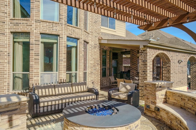 view of patio / terrace featuring an outdoor living space with a fire pit and a pergola