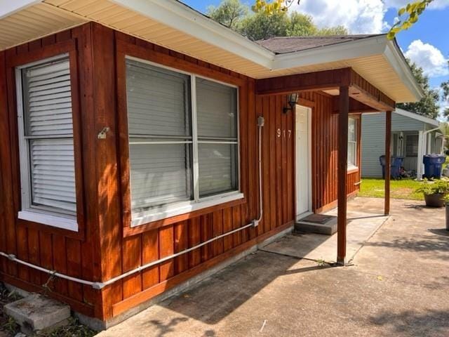 view of exterior entry featuring a patio area