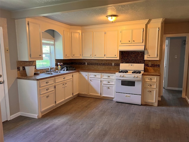 kitchen featuring white cabinets, a textured ceiling, sink, white range with gas stovetop, and dark hardwood / wood-style floors