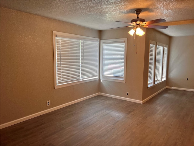 spare room with ceiling fan, dark hardwood / wood-style floors, and a textured ceiling