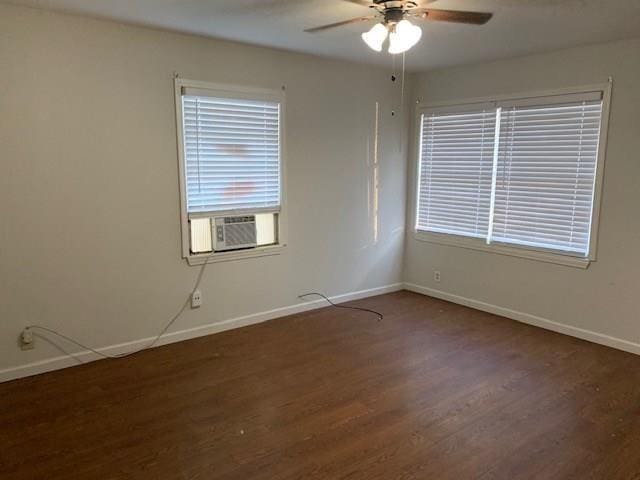 spare room featuring dark hardwood / wood-style floors and ceiling fan