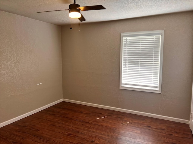 spare room with a textured ceiling, dark hardwood / wood-style flooring, and ceiling fan