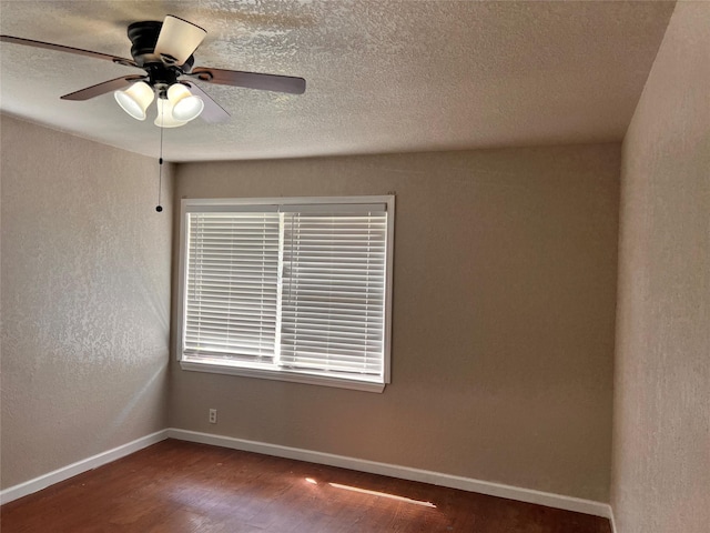 empty room featuring ceiling fan and dark hardwood / wood-style floors