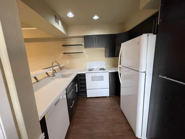 kitchen with sink, dark wood-type flooring, and white appliances