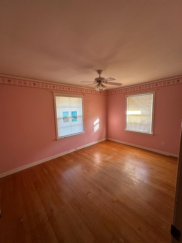 spare room featuring ceiling fan and light hardwood / wood-style flooring