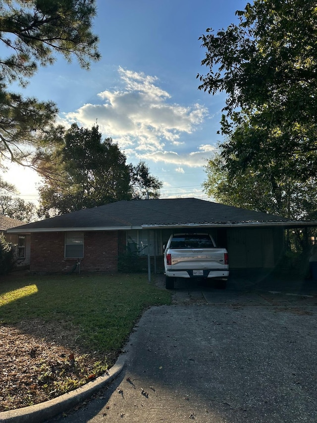 single story home with a carport and a front yard