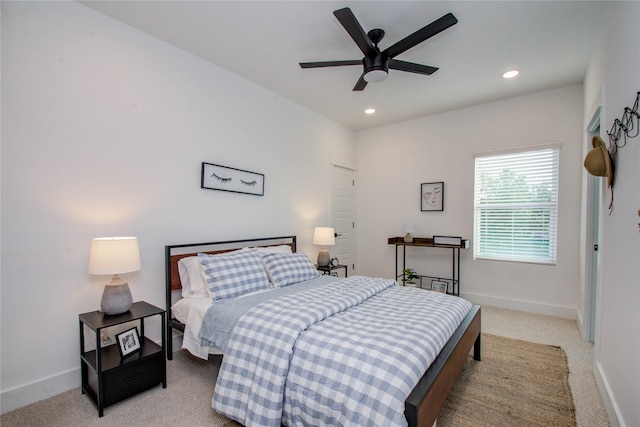 bedroom featuring light colored carpet and ceiling fan