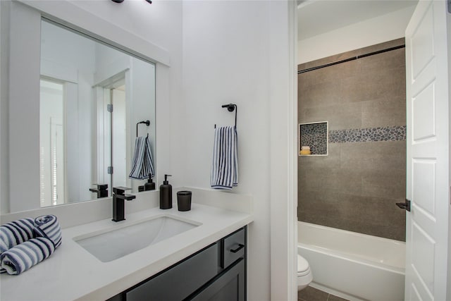 full bathroom featuring vanity, toilet, and tiled shower / bath