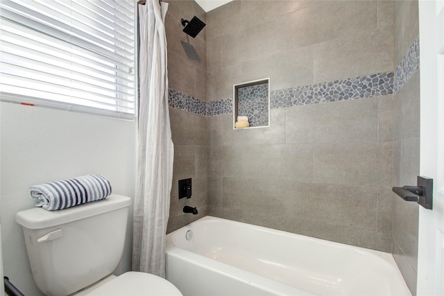 bathroom featuring shower / bath combo with shower curtain and toilet