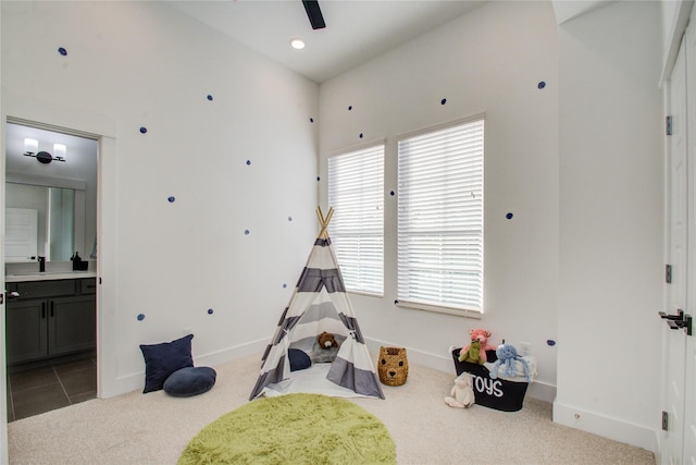 recreation room featuring a wealth of natural light, sink, and light carpet