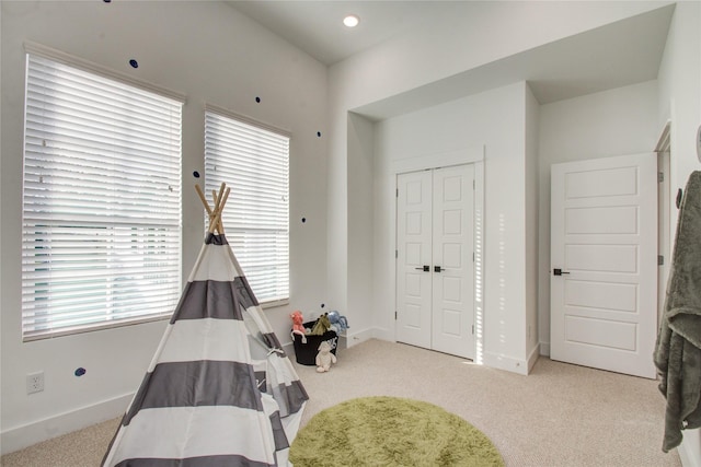 game room featuring light colored carpet