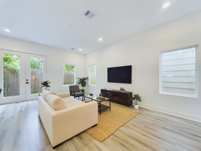 living room with light hardwood / wood-style flooring and french doors