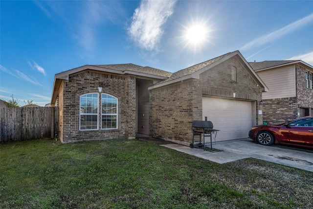 ranch-style home with a garage and a front lawn