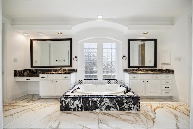 bathroom with crown molding, vanity, and a relaxing tiled tub