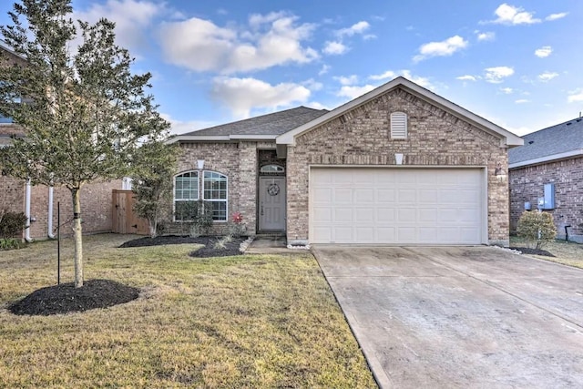 single story home featuring driveway, brick siding, an attached garage, and a front yard
