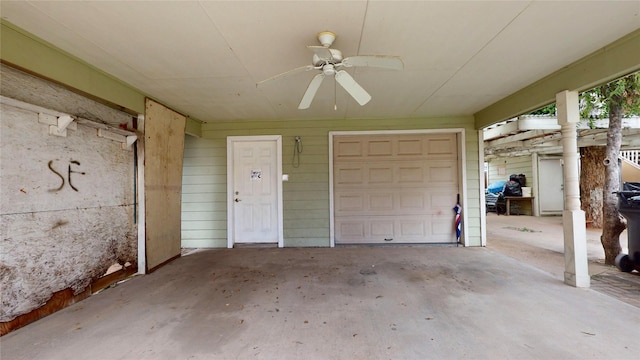 garage with ceiling fan and wooden walls