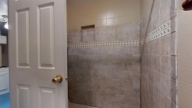 bathroom with a tile shower