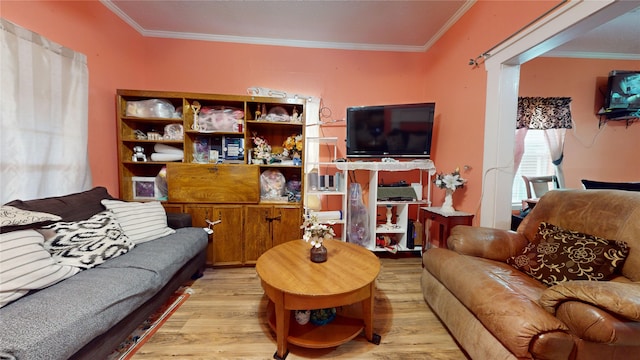 living room featuring light wood-type flooring and crown molding