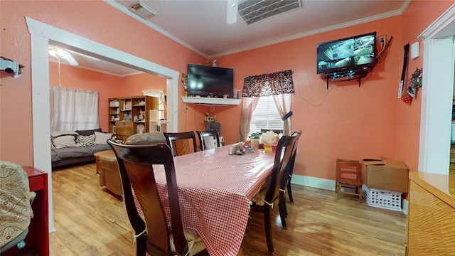 dining room featuring hardwood / wood-style flooring and crown molding