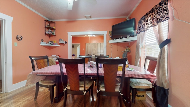 dining area featuring crown molding, hardwood / wood-style floors, and ceiling fan